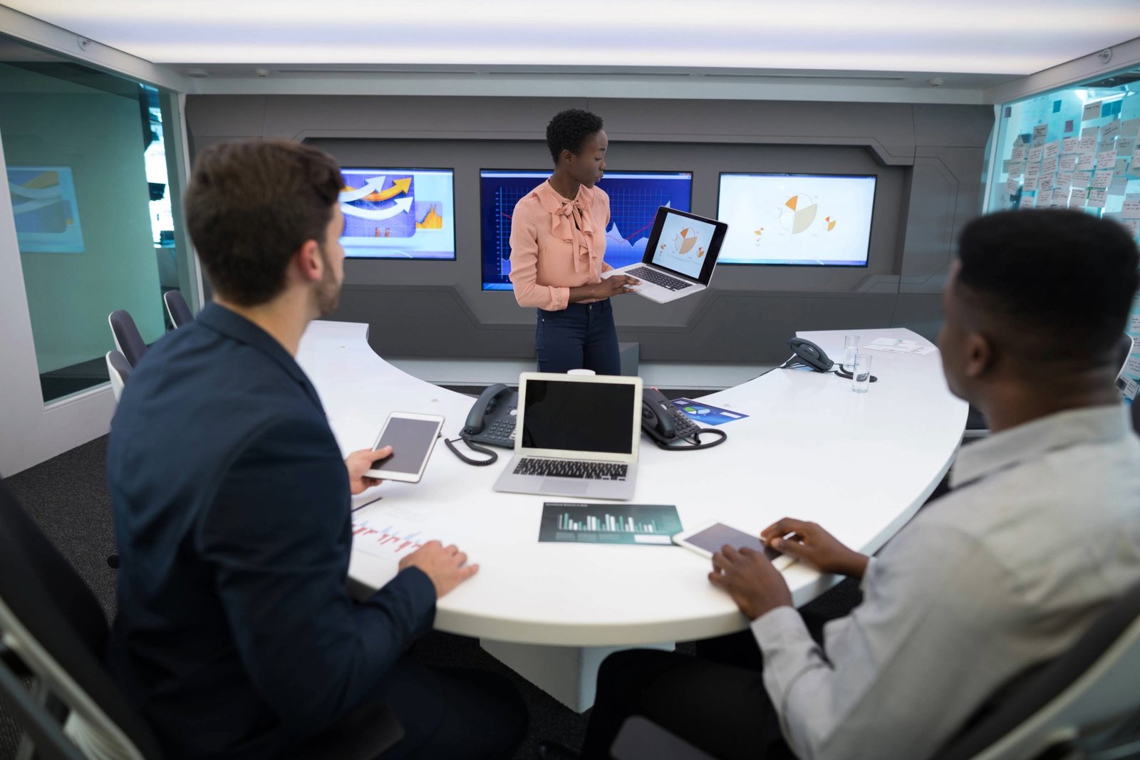 male-and-female-executives-discussing-over-graph-2025-04-04-09-46-18-utc